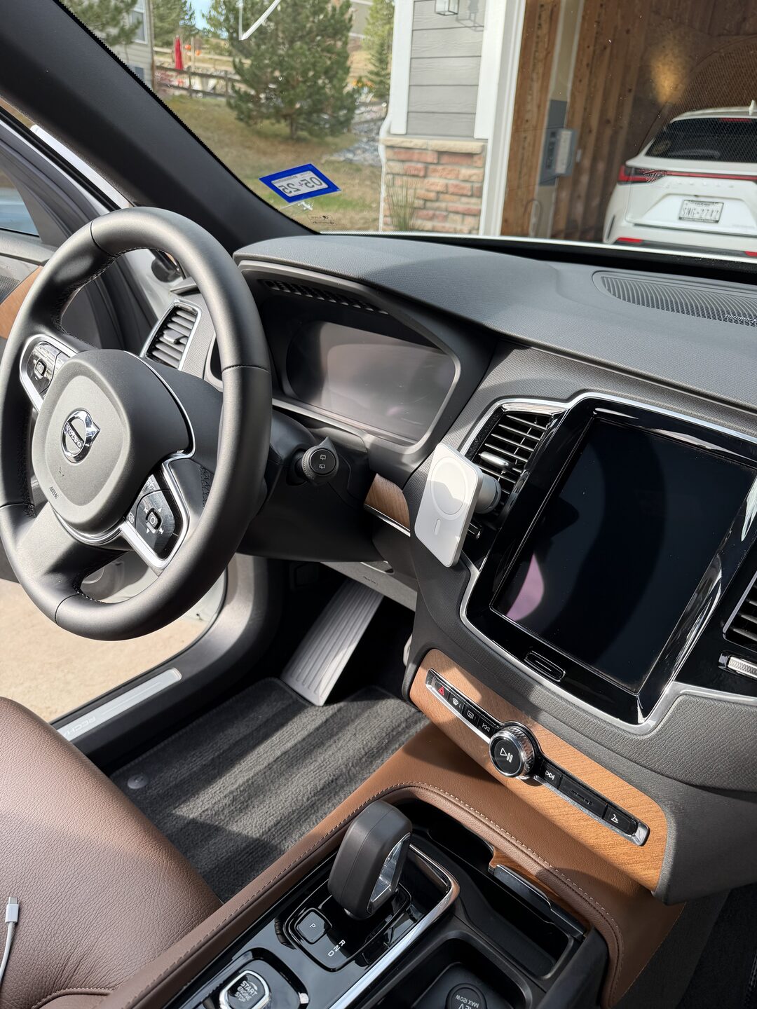 Volvo SUV interior with a detailed dash, conditioned leather, and spotless controls