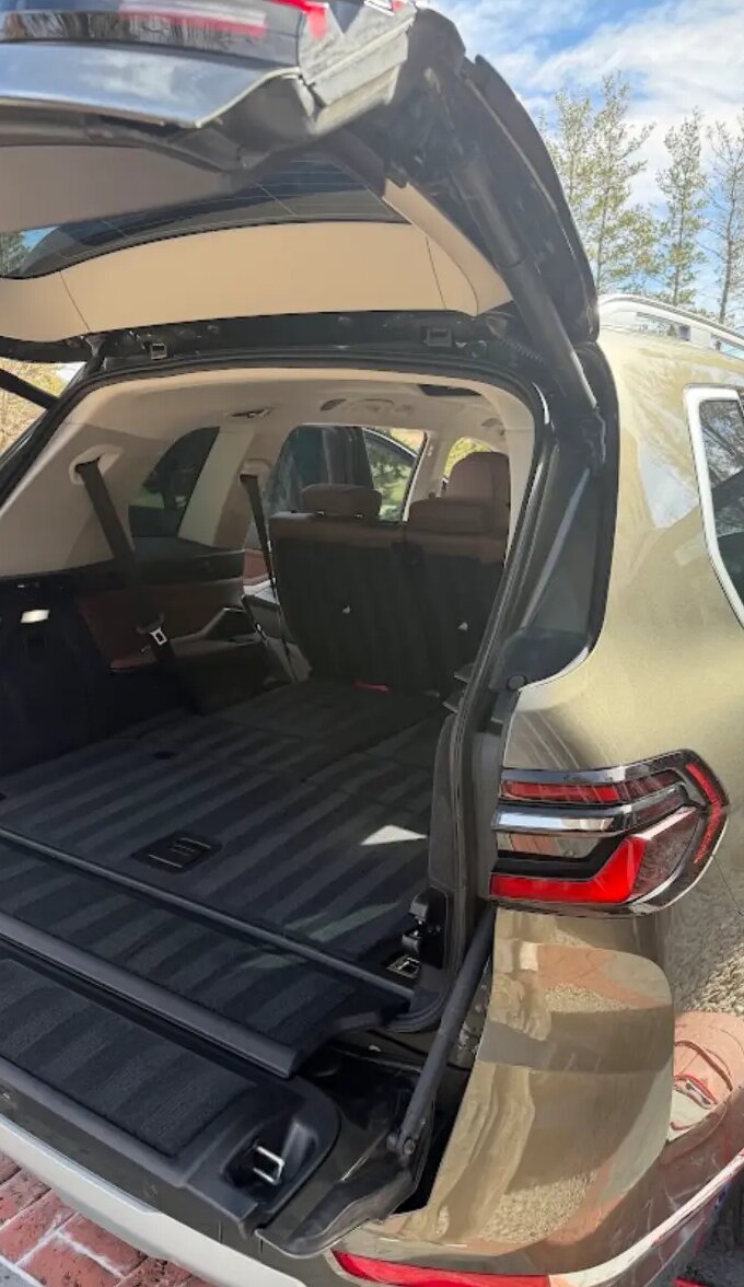 Open cargo area of a BMW X7 after a full interior vacuum and wipe-down