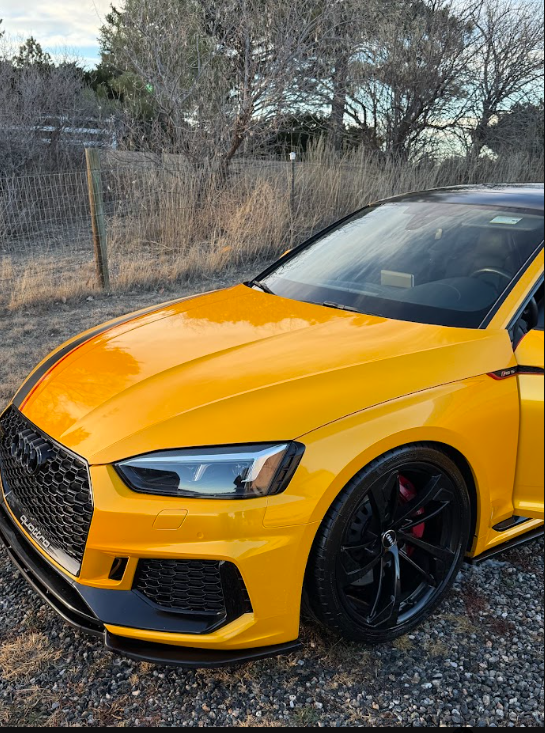 Yellow Audi RS5 with a glossy finish, clean front wheel, and red brake calipers