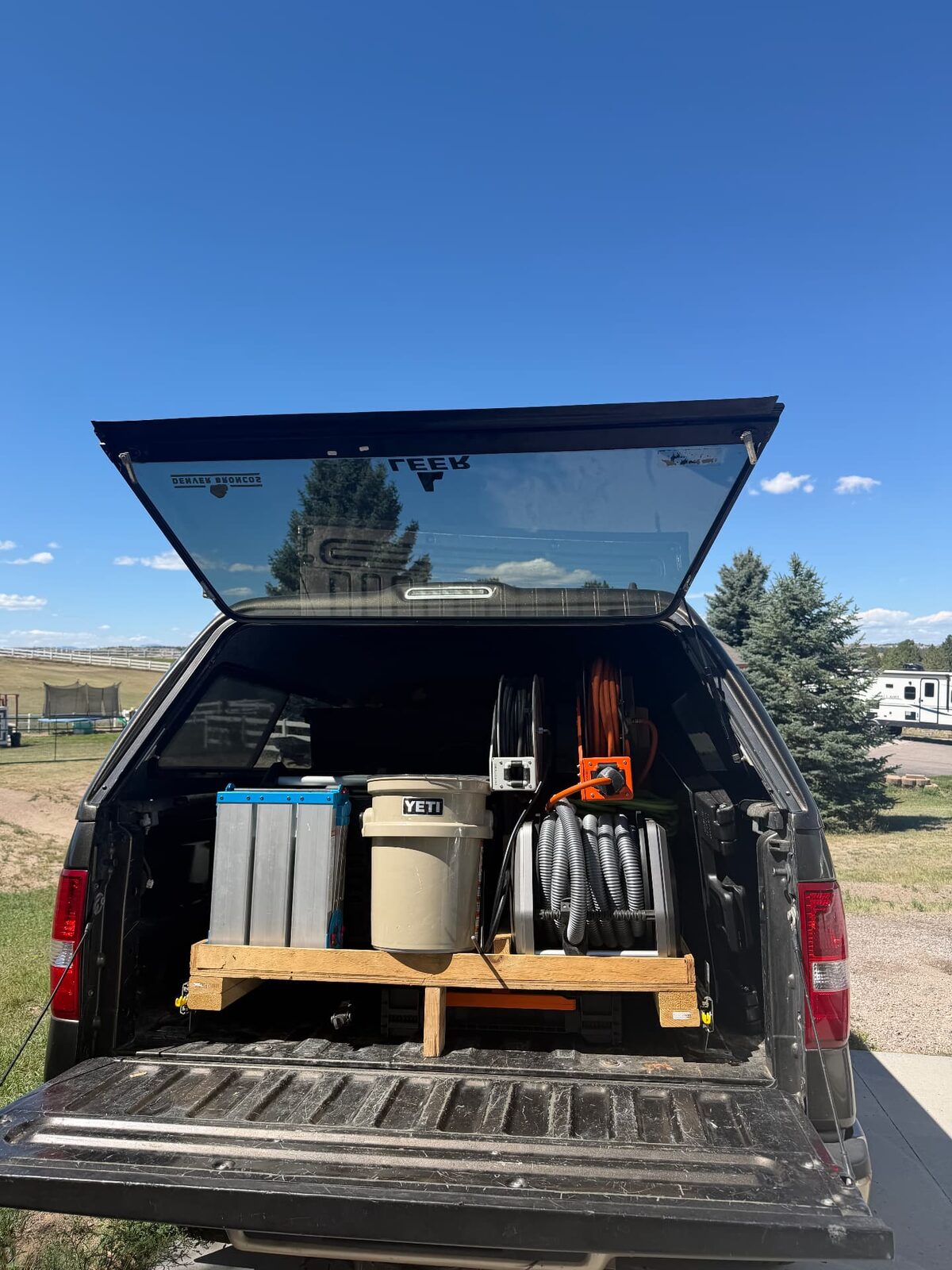 Crystal Clean mobile detailing rig in the back of a pickup with hose reels and tanks